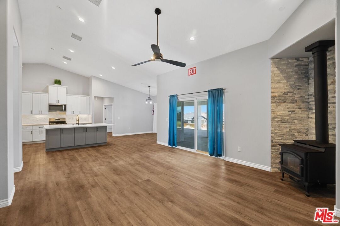 Empty room, Interior, Kitchen, Pendant Lights, Recessed Lighting, Stainless Steel Appliances, Stone Walls, Wood Texture Flooring