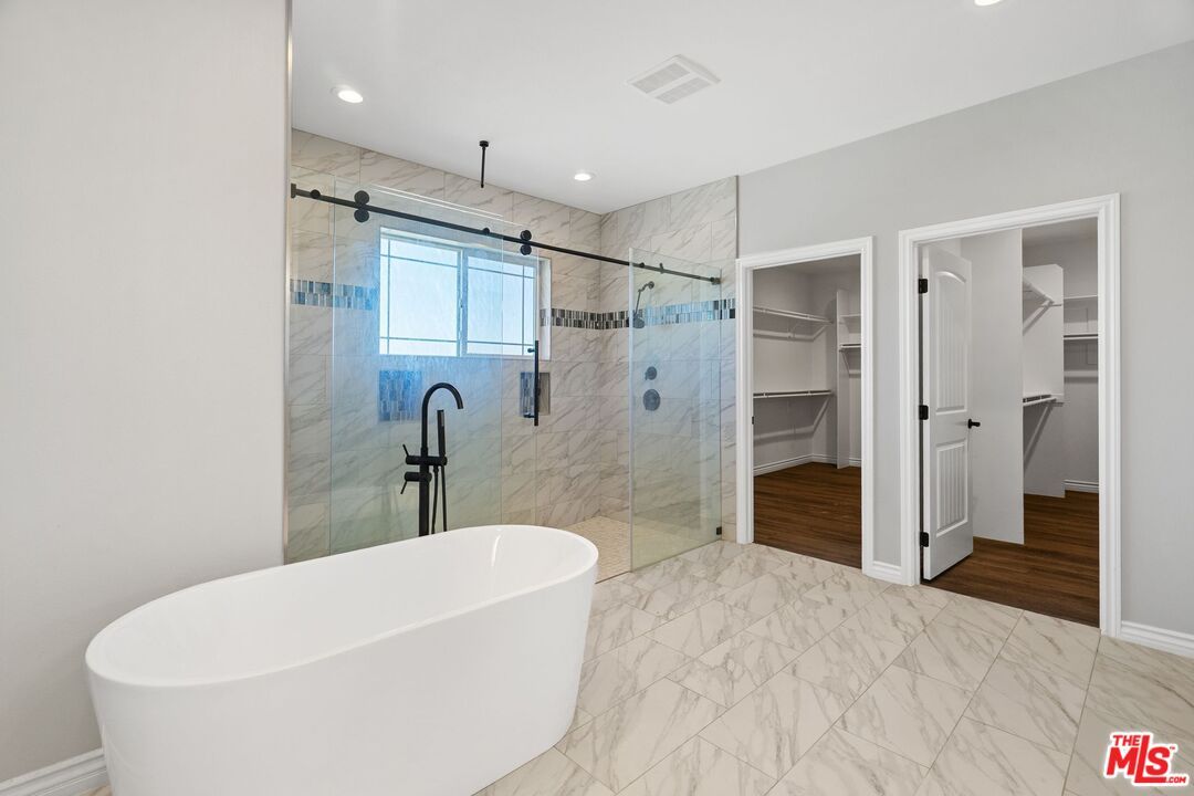 Bathroom, Free Standing Baths, Glass Shower, Interior, Marble, Marble Walls, Recessed Lighting, Wood Texture Flooring