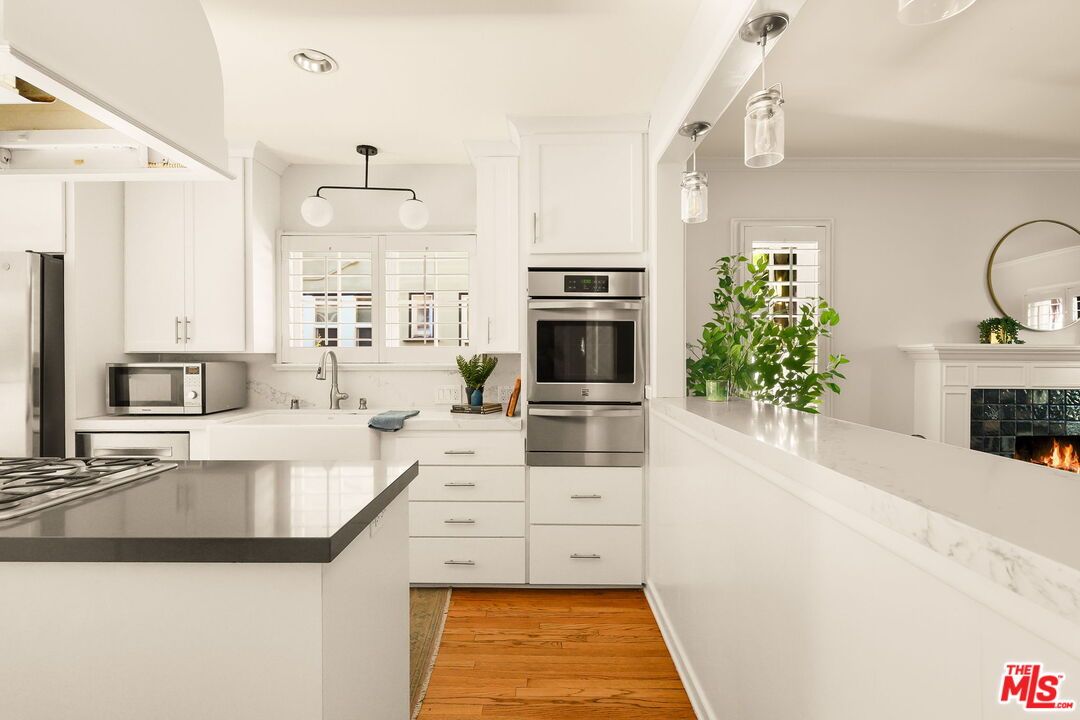 Fireplace, Interior, Kitchen, Pendant Lights, Recessed Lighting, Stainless Steel Appliances, Wood Texture Flooring