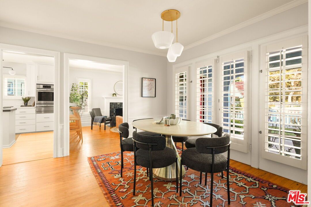 Dining room, Fireplace, Interior, Kitchen, Pendant Lights, Stainless Steel Appliances, Wood Texture Flooring