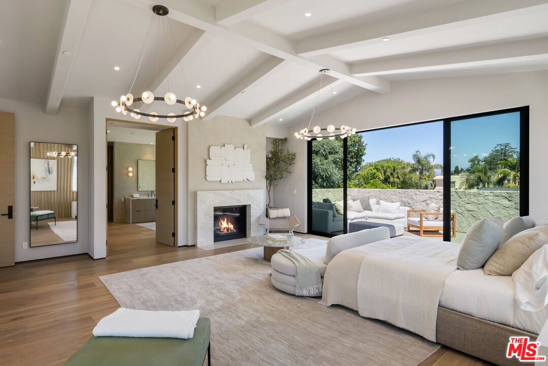 Bedroom, Chandelier, Fireplace, Interior, Living room, Pendant Lights, Recessed Lighting, Wood Texture Flooring