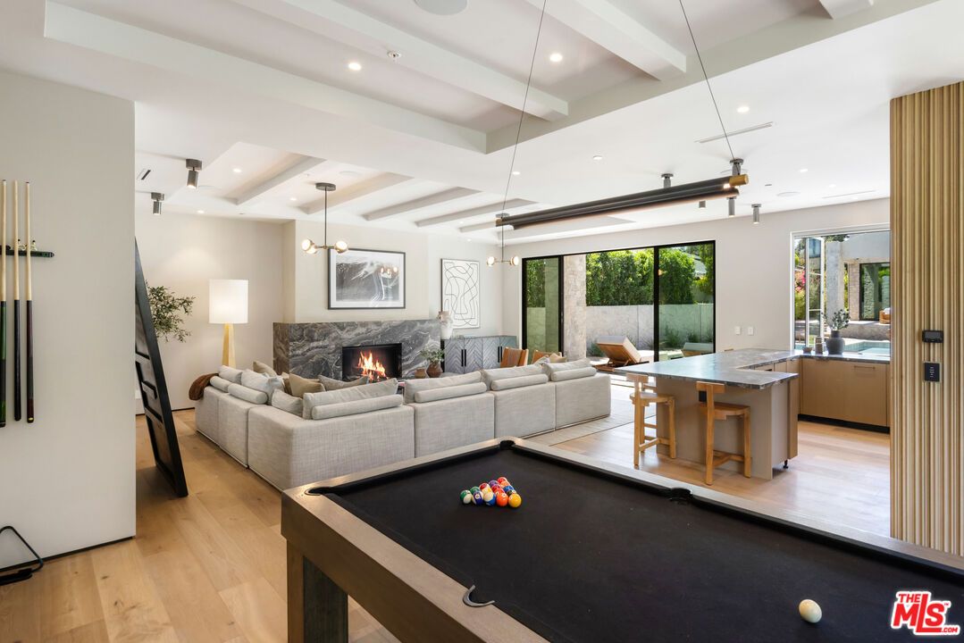 Billiard Table, Fireplace, Game Room, Interior, Living room, Pendant Lights, Recessed Lighting, Wood Texture Flooring