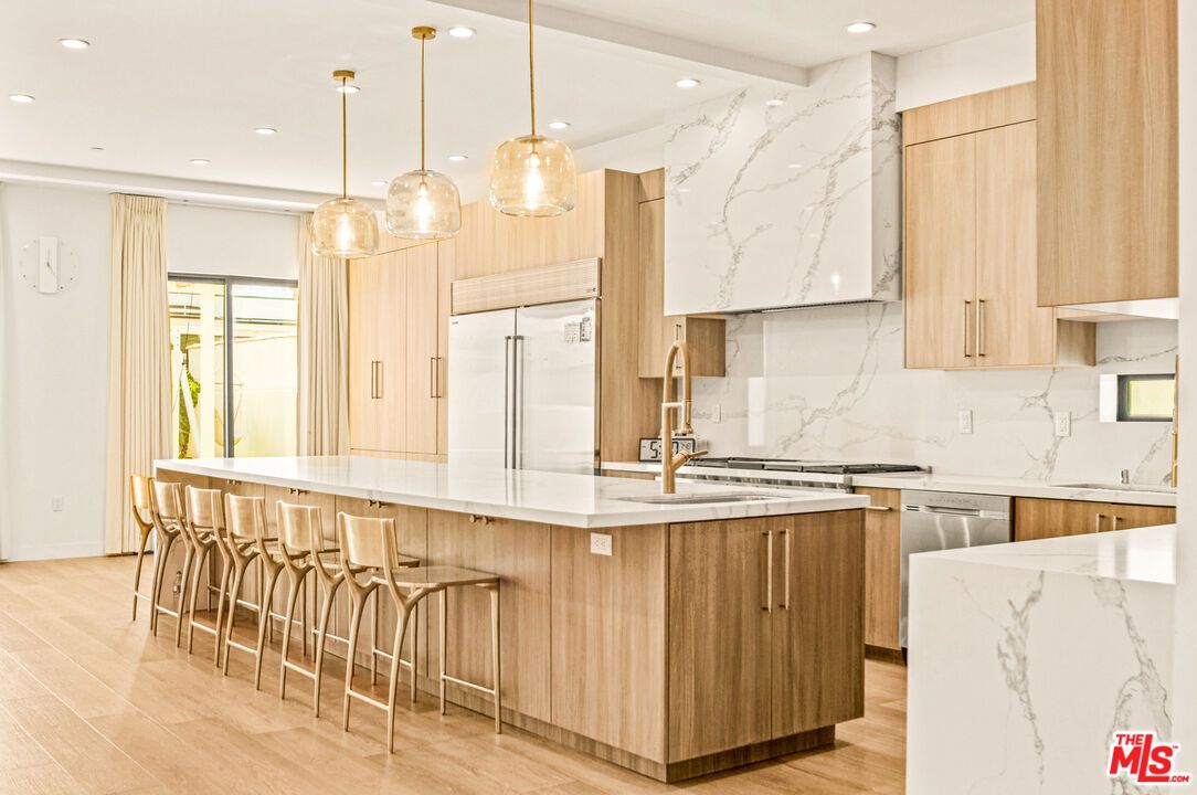 Interior, Kitchen, Marble Walls, Pendant Lights, Recessed Lighting, Stainless Steel Appliances, Wood Texture Flooring