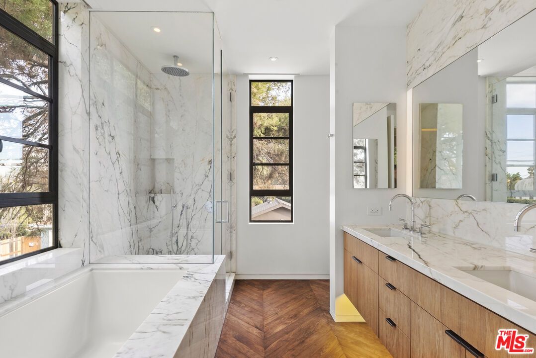 Bathroom, Dual Sink Vanities, Glass Shower, Interior, Marble Walls, Recessed Lighting, Wood Texture Flooring