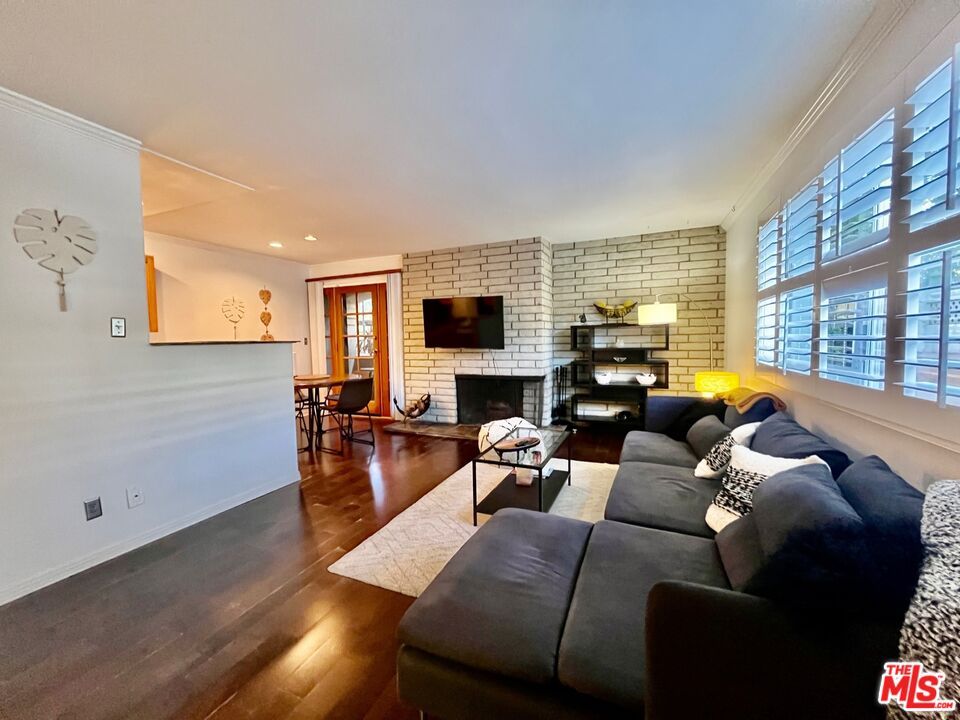 Dining room, Fireplace, Interior, Living room, Recessed Lighting, Stone Walls, Wood Texture Flooring