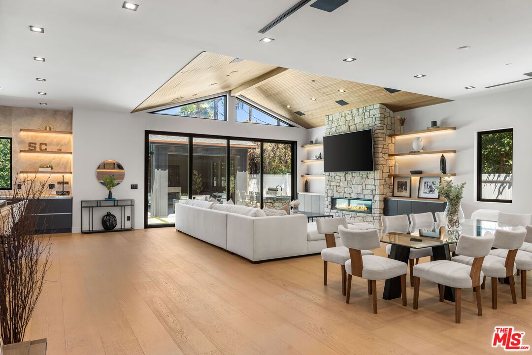 Dining room, Fireplace, Interior, Living room, Recessed Lighting, Stone Walls, Wooden Ceilings, Wood Texture Flooring