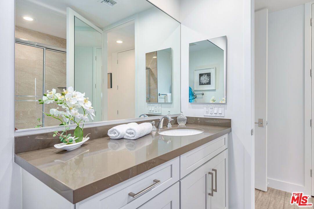 Bathroom, Dual Sink Vanities, Glass Shower, Interior, Recessed Lighting, Wood Texture Flooring
