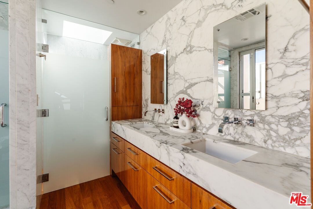 Bathroom, Dual Sink Vanities, Interior, Marble Walls, Recessed Lighting, Wood Texture Flooring