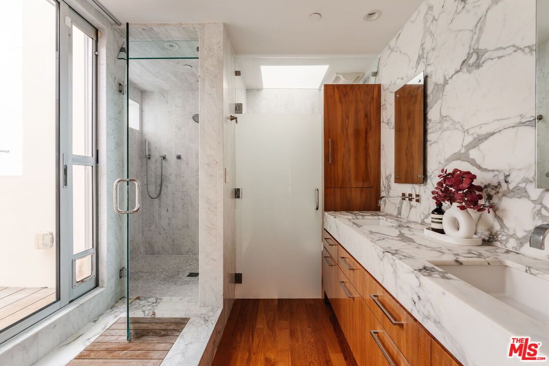 Bathroom, Dual Sink Vanities, Glass Shower, Interior, Marble, Marble Walls, Recessed Lighting, Wood Texture Flooring