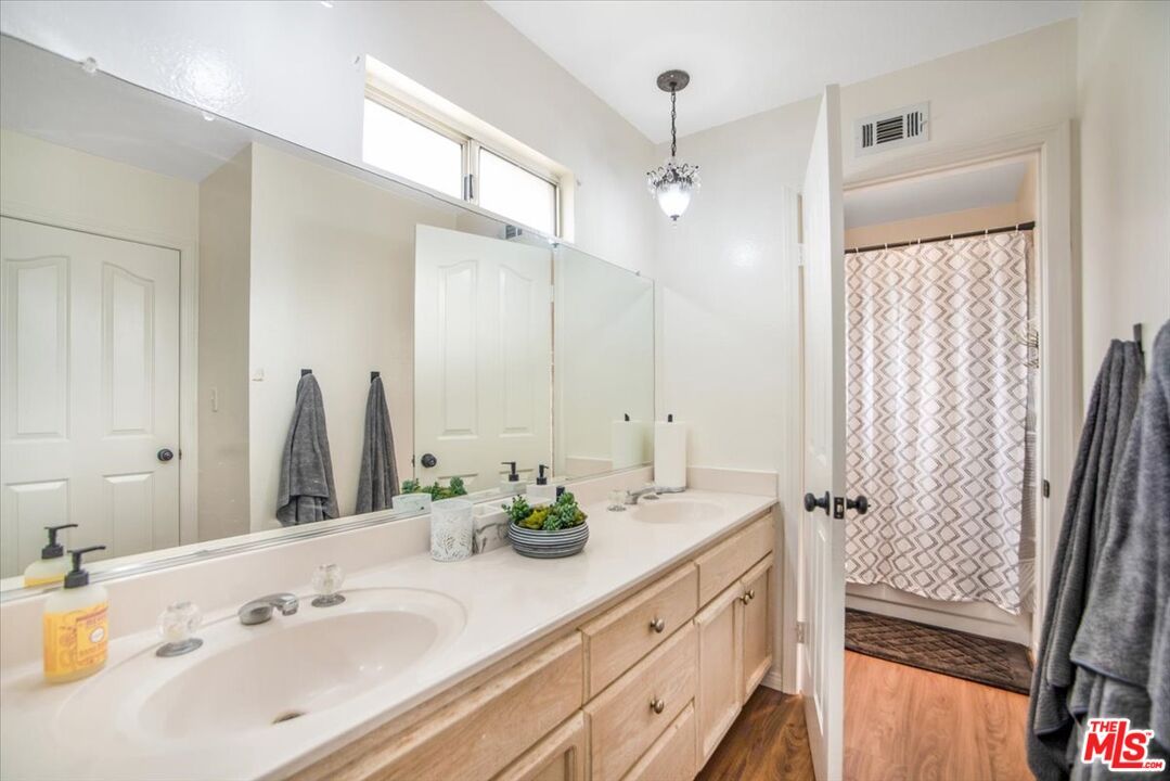 Bathroom, Dual Sink Vanities, Glass Shower, Interior, Pendant Lights, Wood Texture Flooring