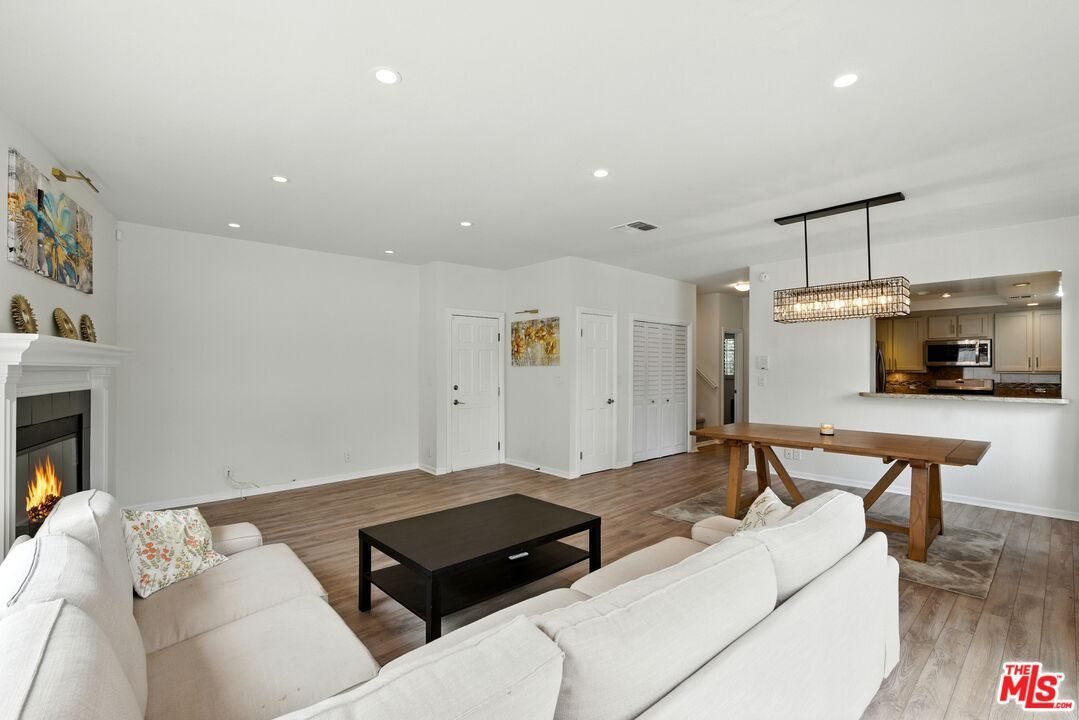 Chandelier, Fireplace, Interior, Kitchen, Living room, Pendant Lights, Recessed Lighting, Wood Texture Flooring