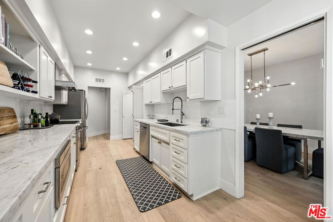 Dining room, Interior, Kitchen, Pendant Lights, Recessed Lighting, Stainless Steel Appliances, Wood Texture Flooring