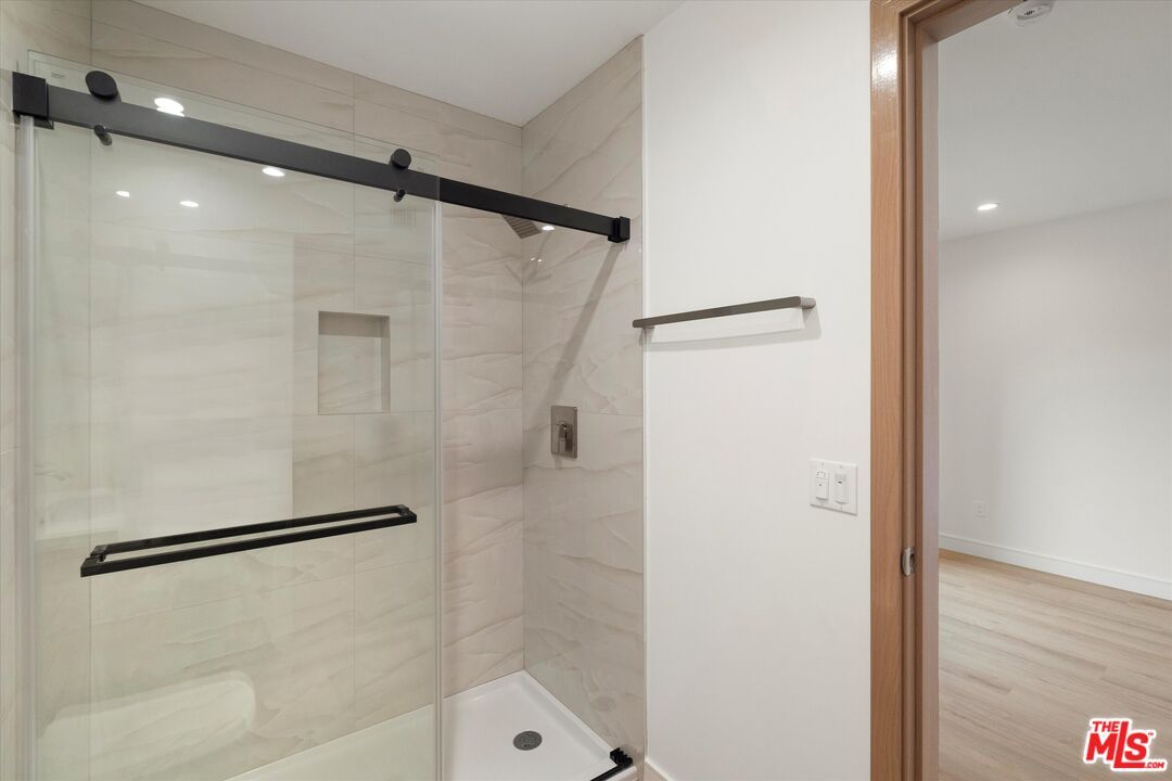 Bathroom, Glass Shower, Interior, Marble Walls, Recessed Lighting, Wood Texture Flooring