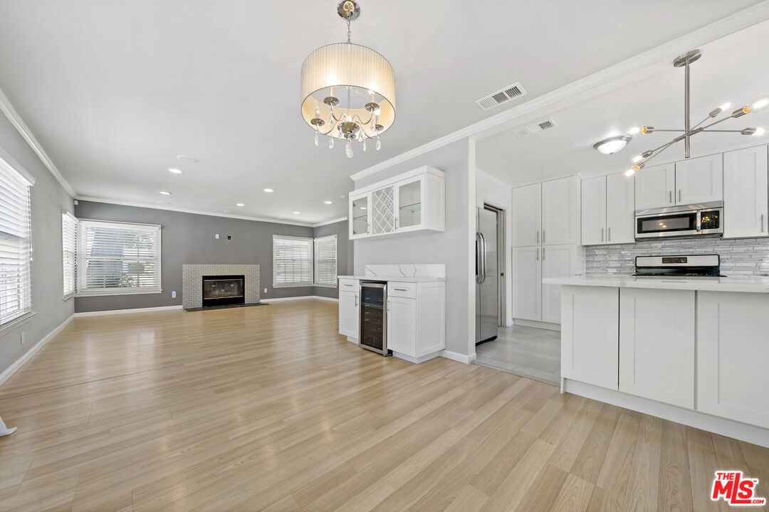 Empty room, Fireplace, Interior, Kitchen, Pendant Lights, Recessed Lighting, Wood Texture Flooring