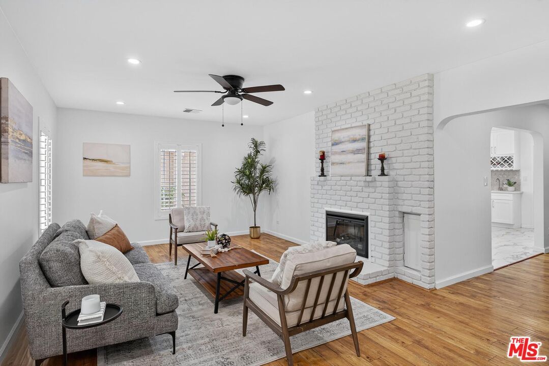 Fireplace, Interior, Living room, Recessed Lighting, Stone Walls, Wood Texture Flooring