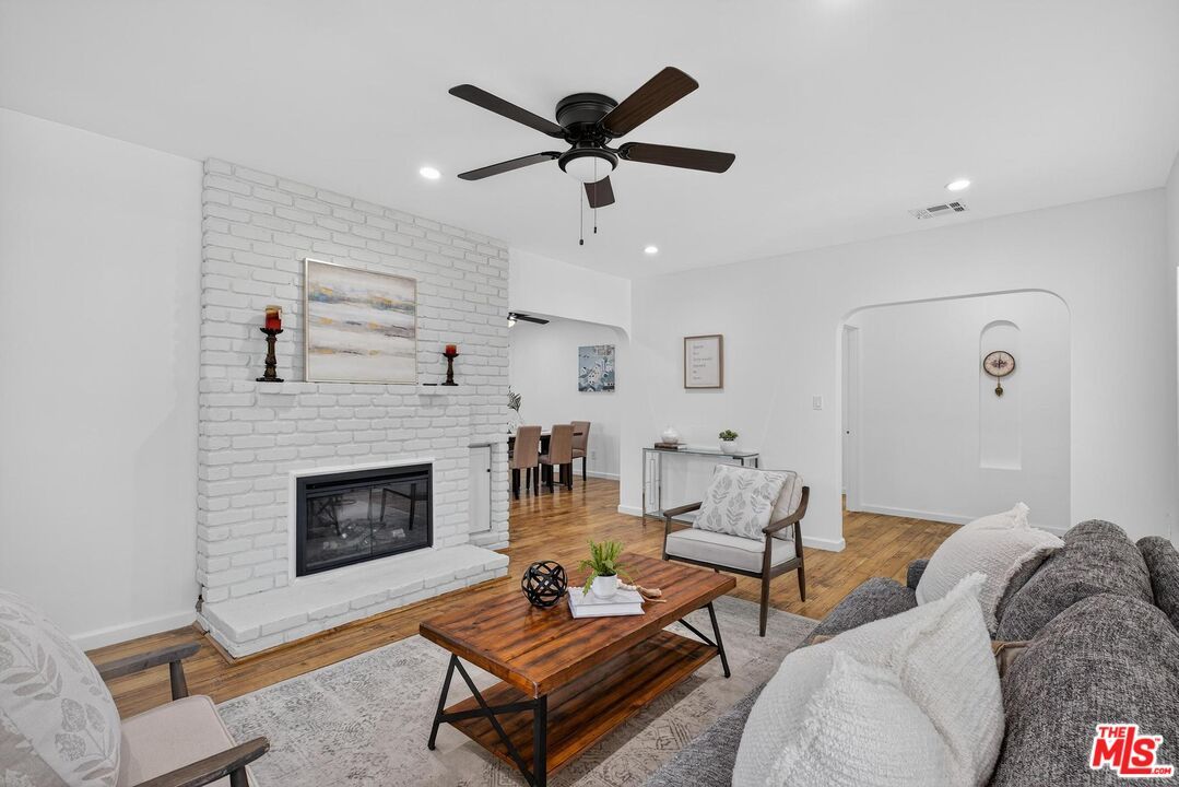 Dining room, Fireplace, Interior, Living room, Recessed Lighting, Stone Walls, Wood Texture Flooring