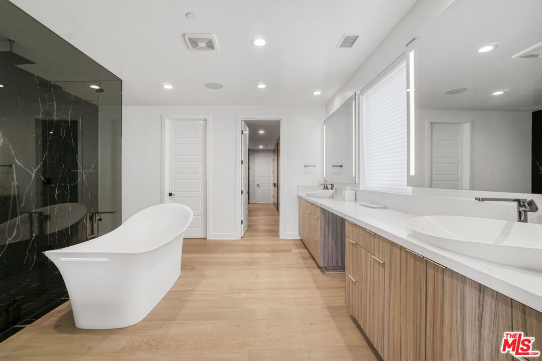 Bathroom, Dual Sink Vanities, Free Standing Baths, Interior, Marble Walls, Recessed Lighting, Wood Texture Flooring