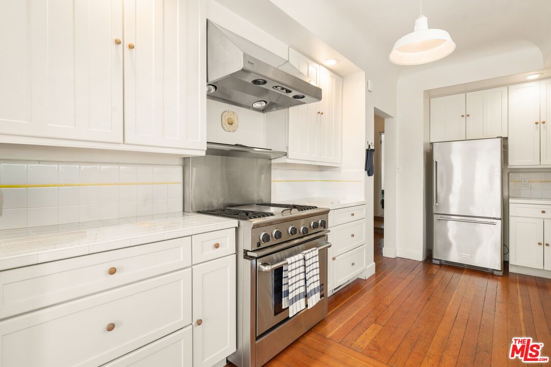 Interior, Kitchen, Pendant Lights, Recessed Lighting, Stainless Steel Appliances, Tile Countertops, Wood Texture Flooring