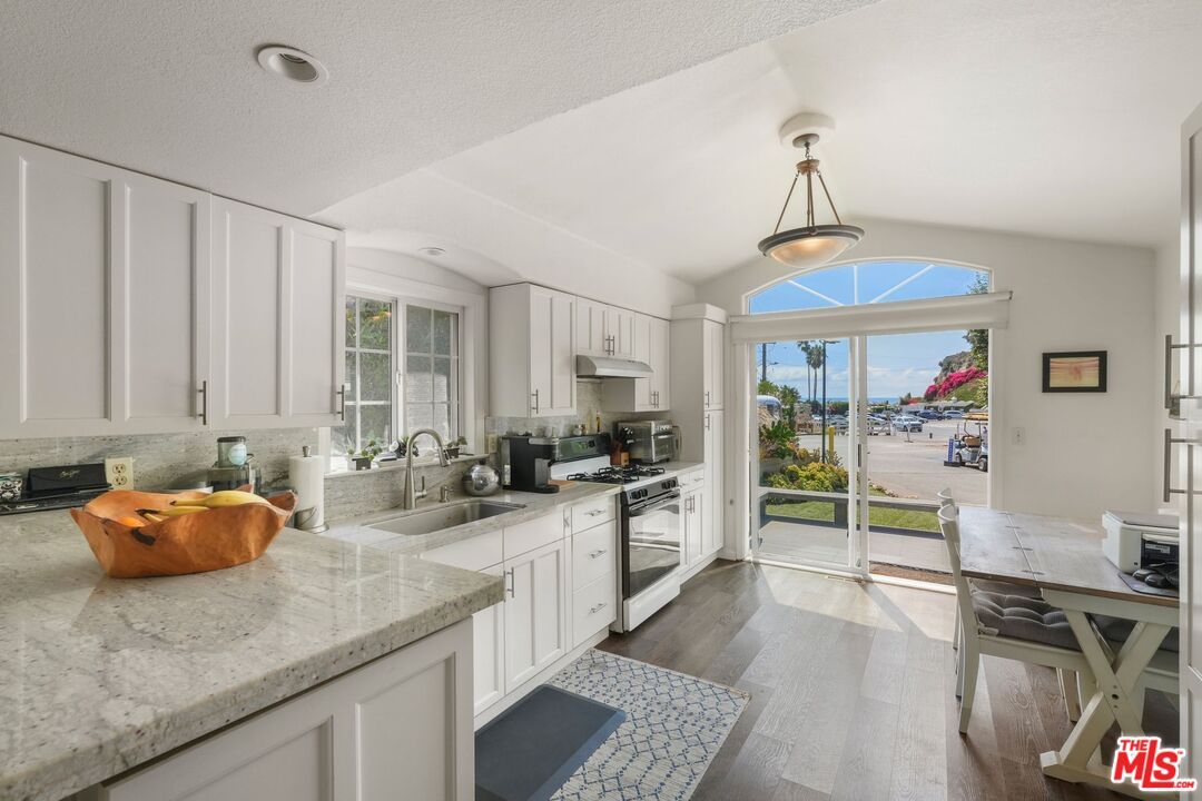 Dining room, Interior, Kitchen, Pendant Lights, Recessed Lighting, Stainless Steel Appliances, Water, Wood Texture Flooring