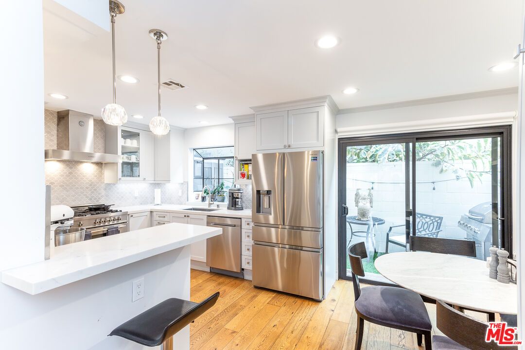 Dining room, Interior, Kitchen, Pendant Lights, Recessed Lighting, Stainless Steel Appliances, Wood Texture Flooring