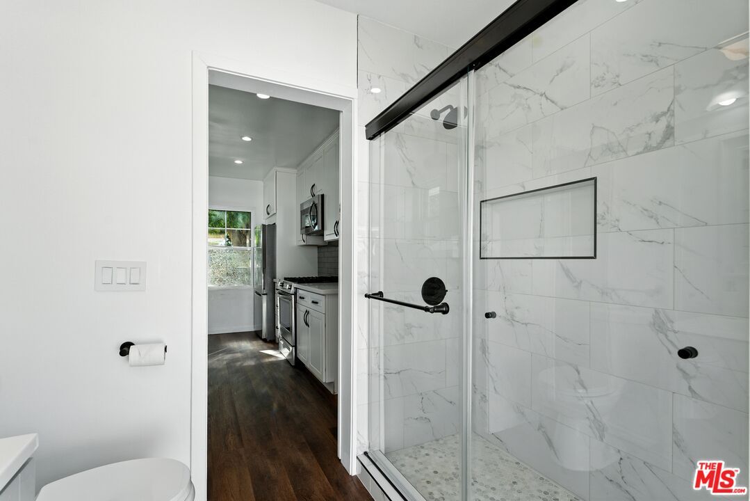 Bathroom, Glass Shower, Interior, Marble Walls, Recessed Lighting, Wood Texture Flooring