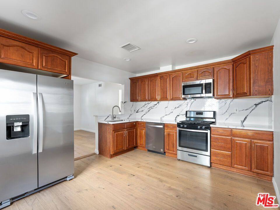 Interior, Kitchen, Marble Walls, Recessed Lighting, Stainless Steel Appliances, Wood Texture Flooring