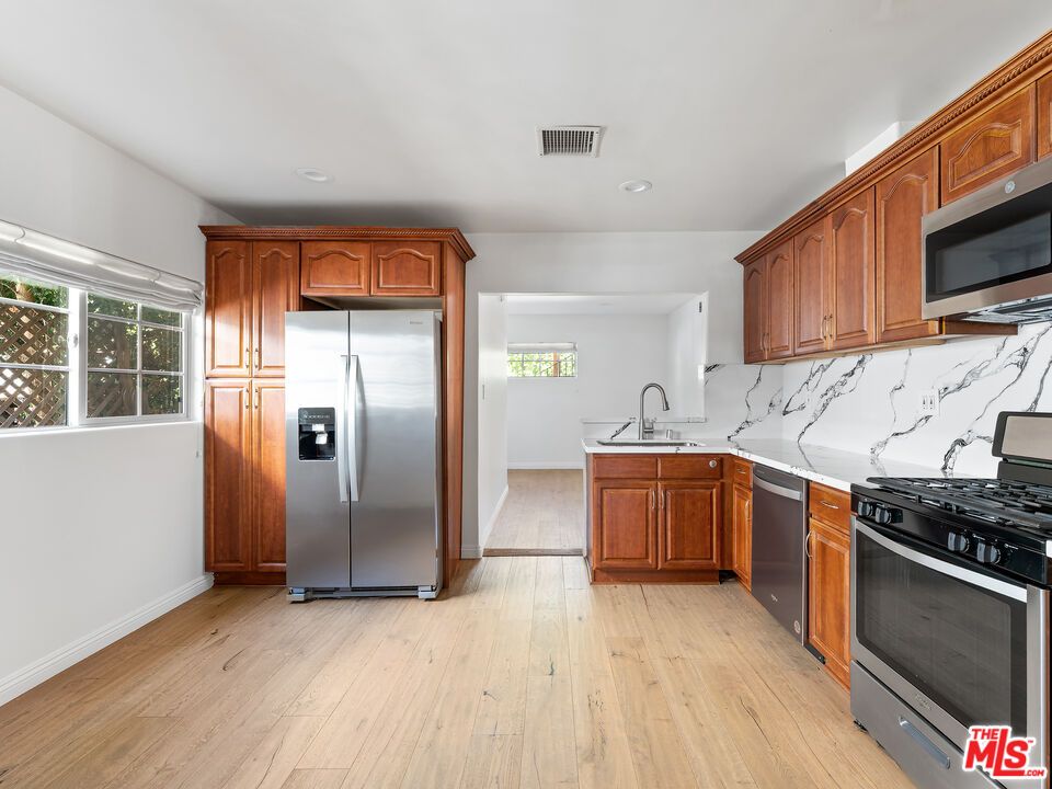 Interior, Kitchen, Marble Walls, Recessed Lighting, Stainless Steel Appliances, Wood Texture Flooring
