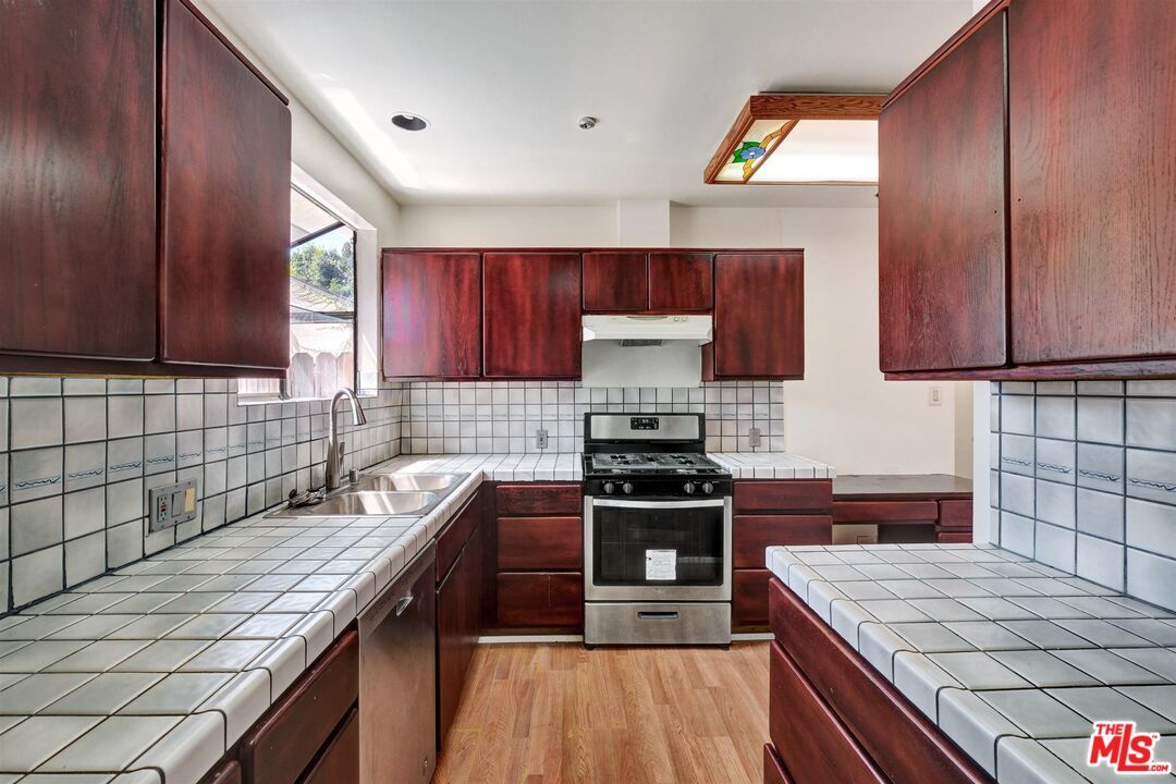 Interior, Kitchen, Recessed Lighting, Stainless Steel Appliances, Tile Countertops, Wood Texture Flooring