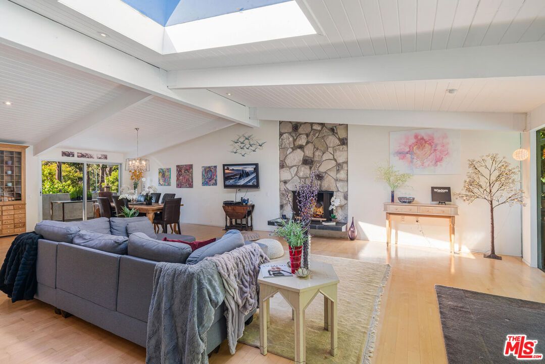 Chandelier, Dining room, Fireplace, Interior, Living room, Pendant Lights, Recessed Lighting, Stone Walls, Wood Texture Flooring