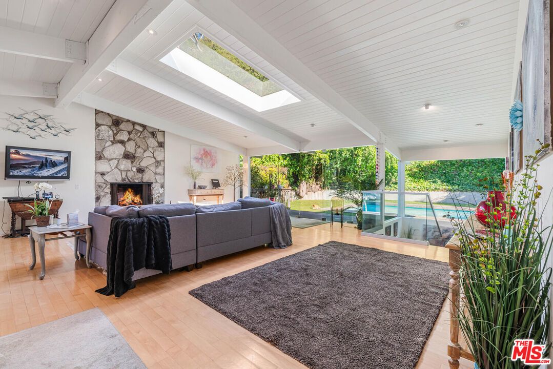 Fireplace, Interior, Living room, Recessed Lighting, Stone Walls, Wood Texture Flooring