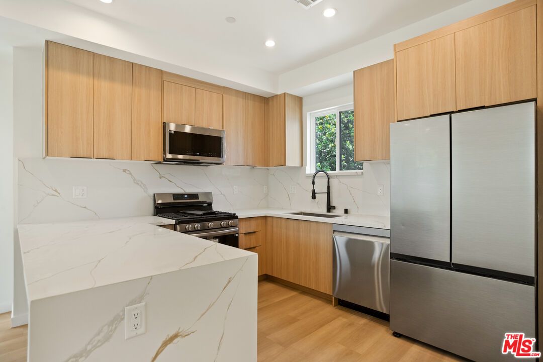 Interior, Kitchen, Marble Walls, Recessed Lighting, Stainless Steel Appliances, Wood Texture Flooring