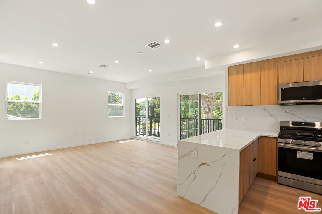 Interior, Kitchen, Marble Walls, Recessed Lighting, Stainless Steel Appliances, Wood Texture Flooring
