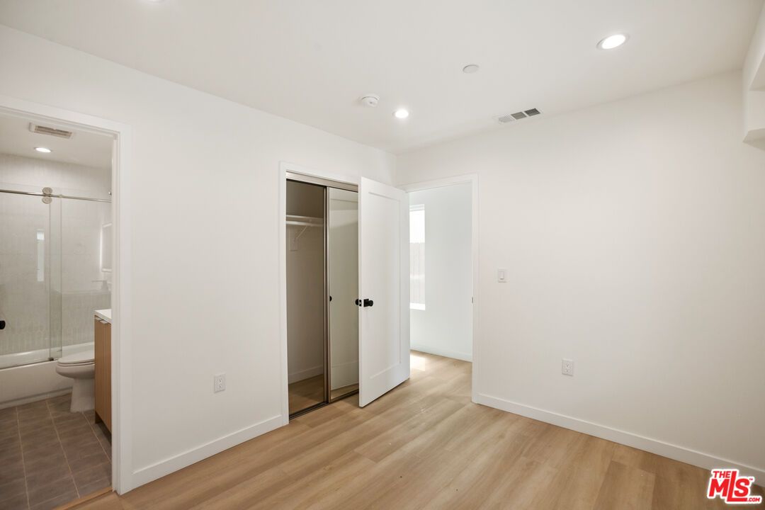 Bathroom, Empty room, Glass Shower, Interior, Recessed Lighting, Wood Texture Flooring