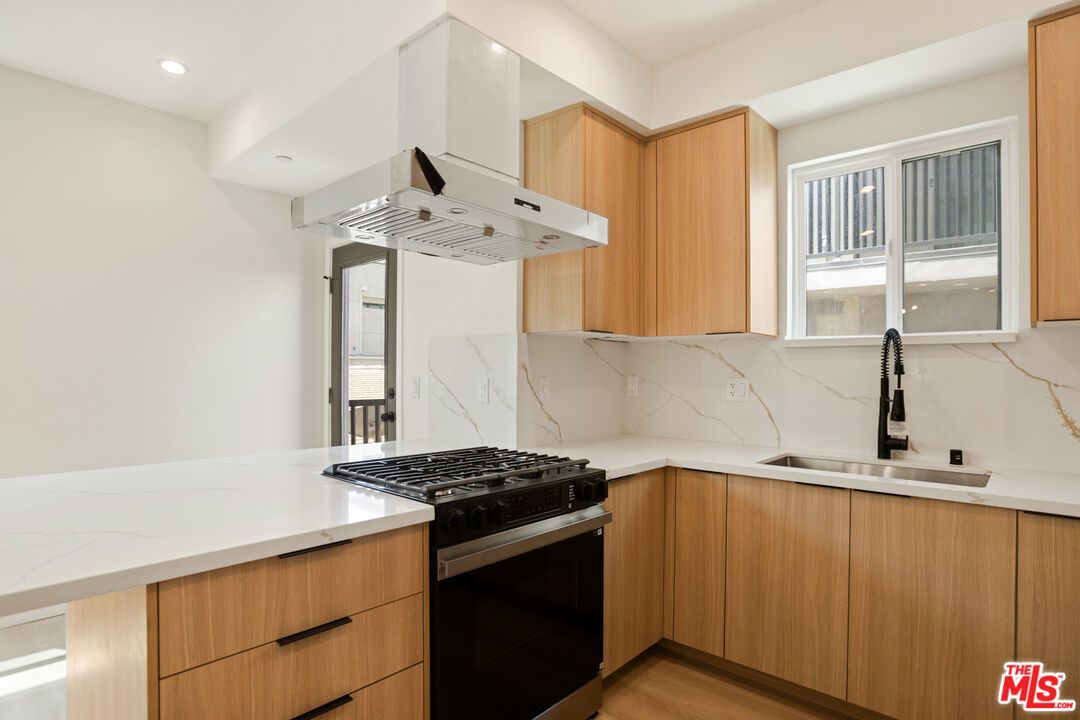 Interior, Kitchen, Marble Walls, Recessed Lighting, Stainless Steel Appliances, Wood Texture Flooring