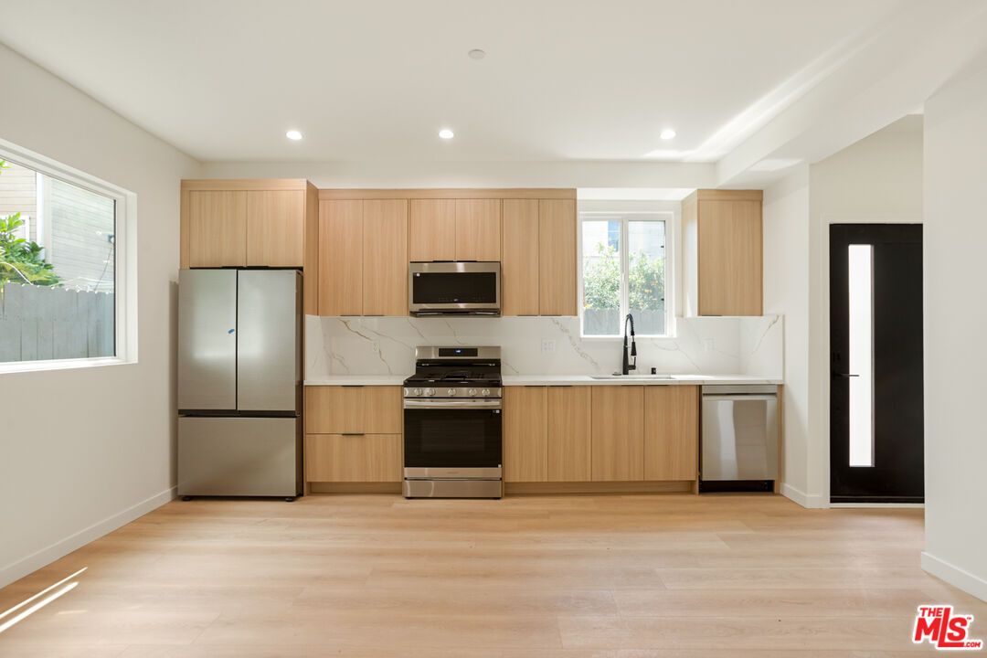 Interior, Kitchen, Marble Walls, Recessed Lighting, Stainless Steel Appliances, Wood Texture Flooring