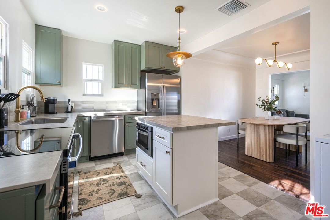 Chandelier, Dining room, Interior, Kitchen, Pendant Lights, Recessed Lighting, Stainless Steel Appliances, Wood Texture Flooring