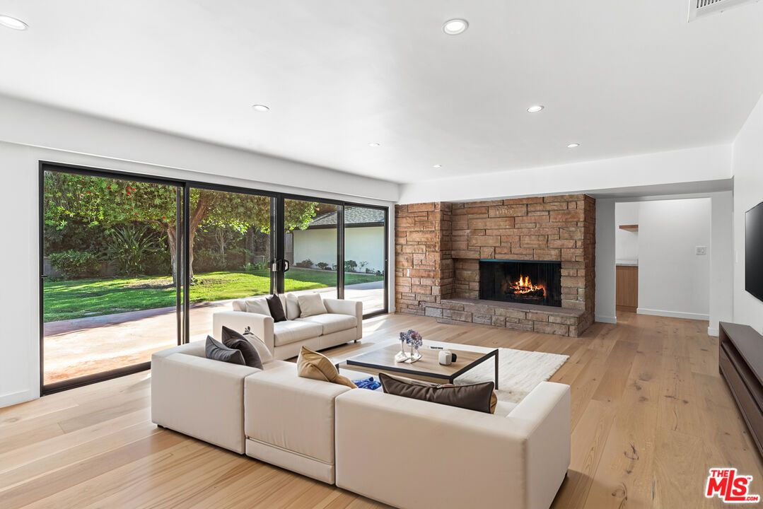 Fireplace, Interior, Living room, Recessed Lighting, Stone Walls, Wood Texture Flooring