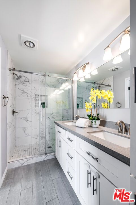 Bathroom, Dual Sink Vanities, Glass Shower, Interior, Marble Walls, Wood Texture Flooring