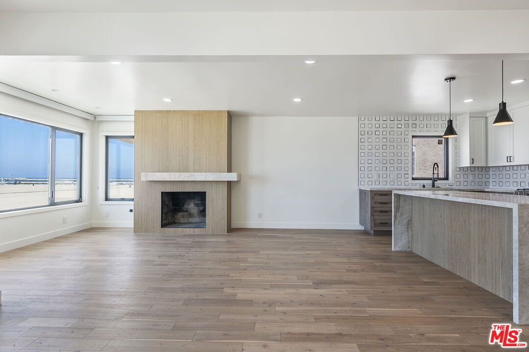 Empty room, Fireplace, Interior, Kitchen, Pendant Lights, Recessed Lighting, Wood Texture Flooring