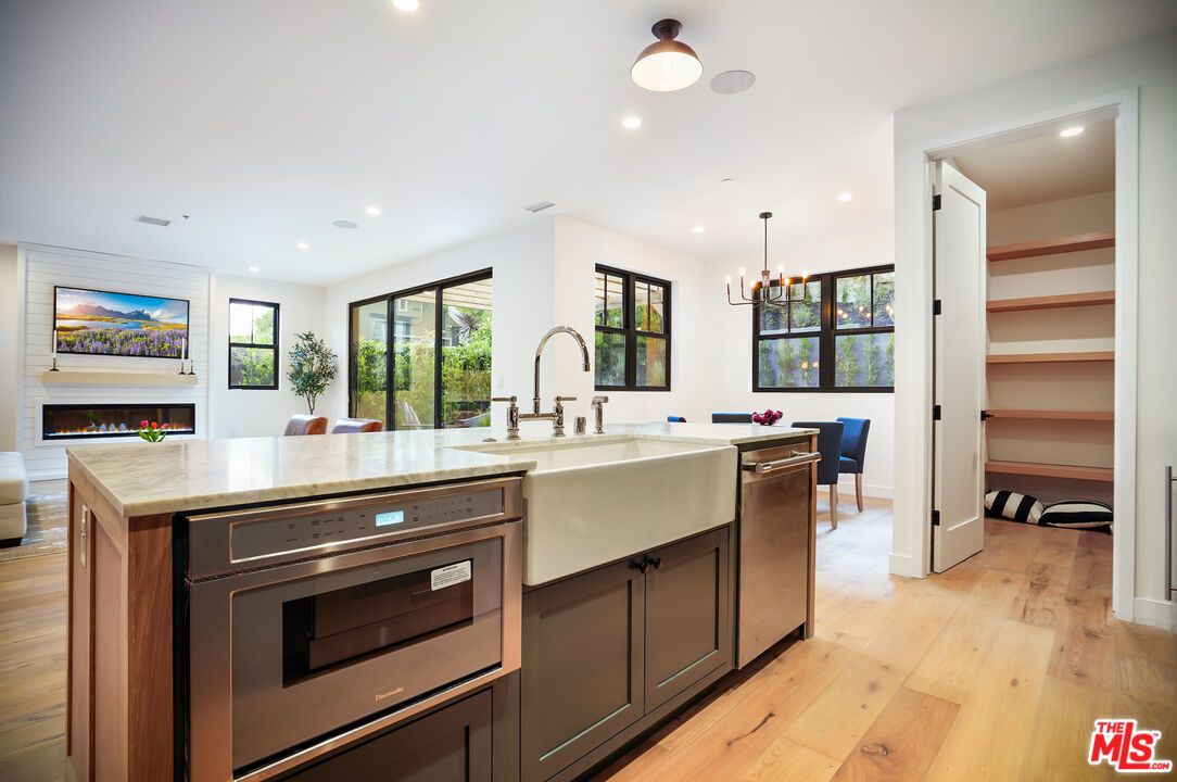 Chandelier, Dining room, Fireplace, Interior, Kitchen, Pendant Lights, Recessed Lighting, Stainless Steel Appliances, Wood Texture Flooring