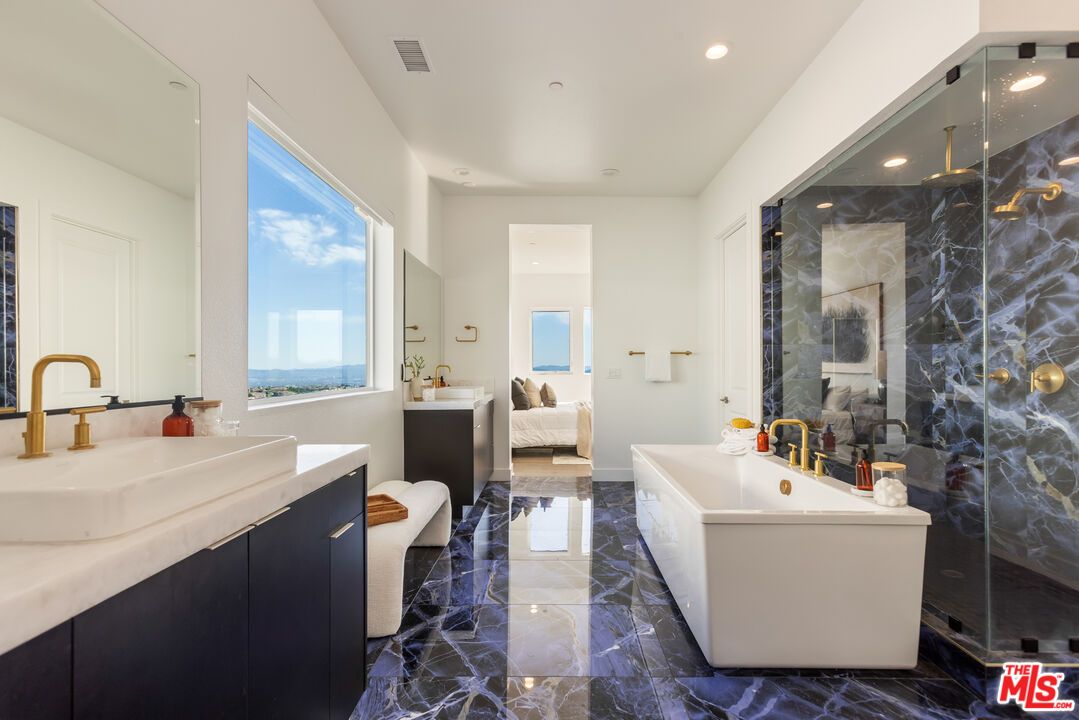 Bathroom, Dual Sink Vanities, Free Standing Baths, Glass Shower, Interior, Marble, Marble Walls, Recessed Lighting, Water