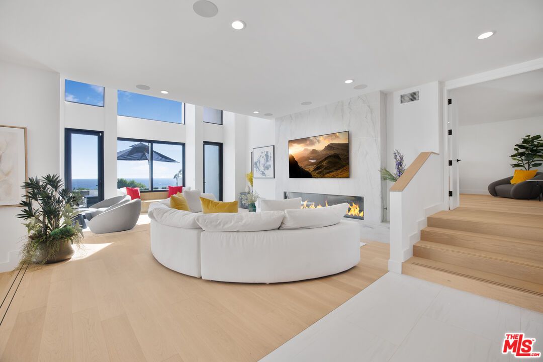 Fireplace, Interior, Living room, Marble Walls, Recessed Lighting, Water, Wood Texture Flooring