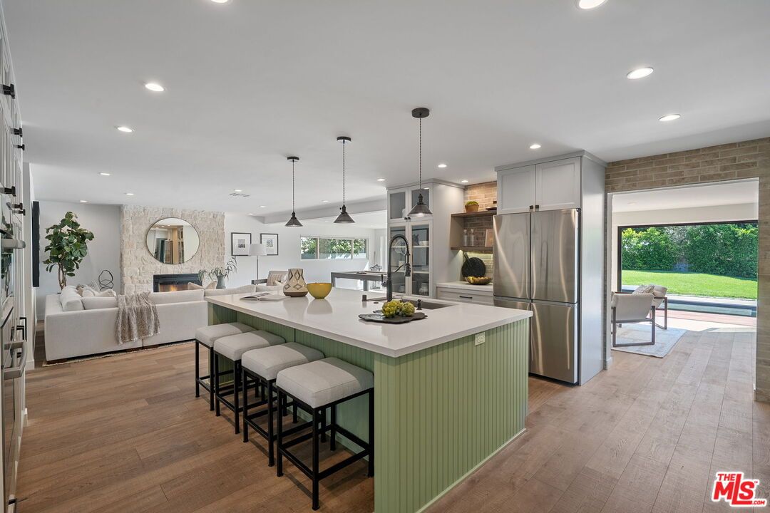Fireplace, Interior, Kitchen, Living room, Pendant Lights, Recessed Lighting, Stainless Steel Appliances, Stone Walls, Wood Texture Flooring