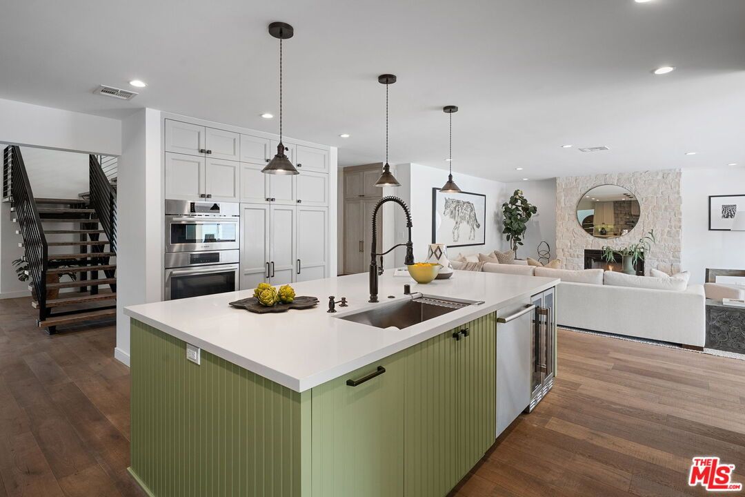 Fireplace, Interior, Kitchen, Living room, Pendant Lights, Recessed Lighting, Stainless Steel Appliances, Stone Walls, Wood Texture Flooring