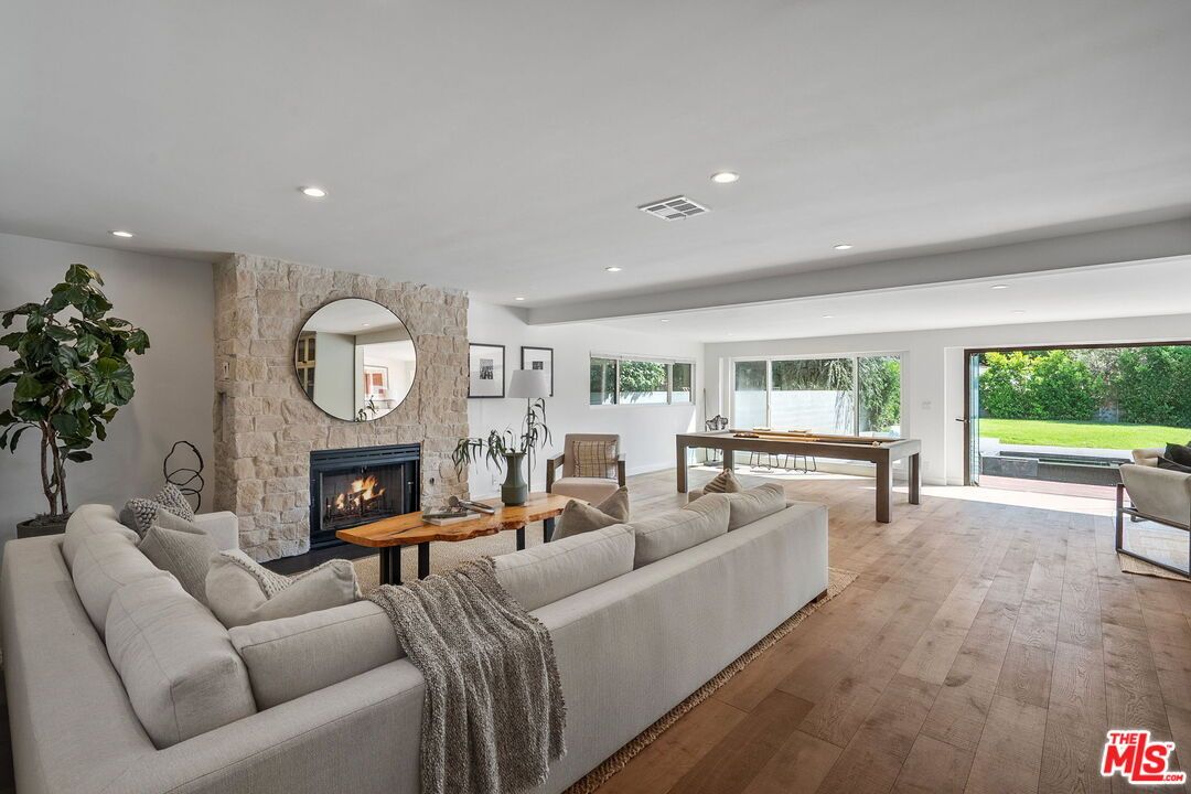 Billiard Table, Fireplace, Game Room, Interior, Living room, Recessed Lighting, Stone Walls, Wood Texture Flooring