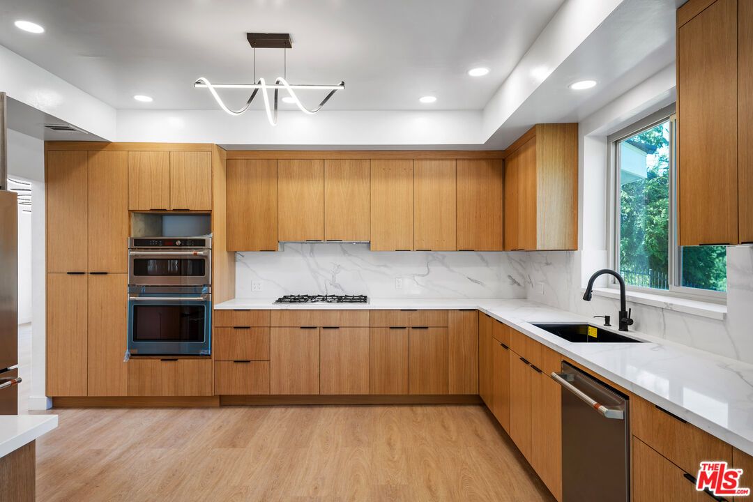 Interior, Kitchen, Marble Walls, Recessed Lighting, Stainless Steel Appliances, Wood Texture Flooring