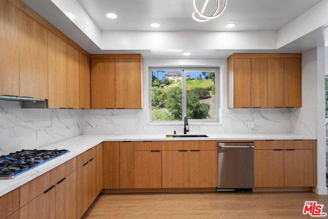 Interior, Kitchen, Marble Walls, Recessed Lighting, Stainless Steel Appliances, Wood Texture Flooring