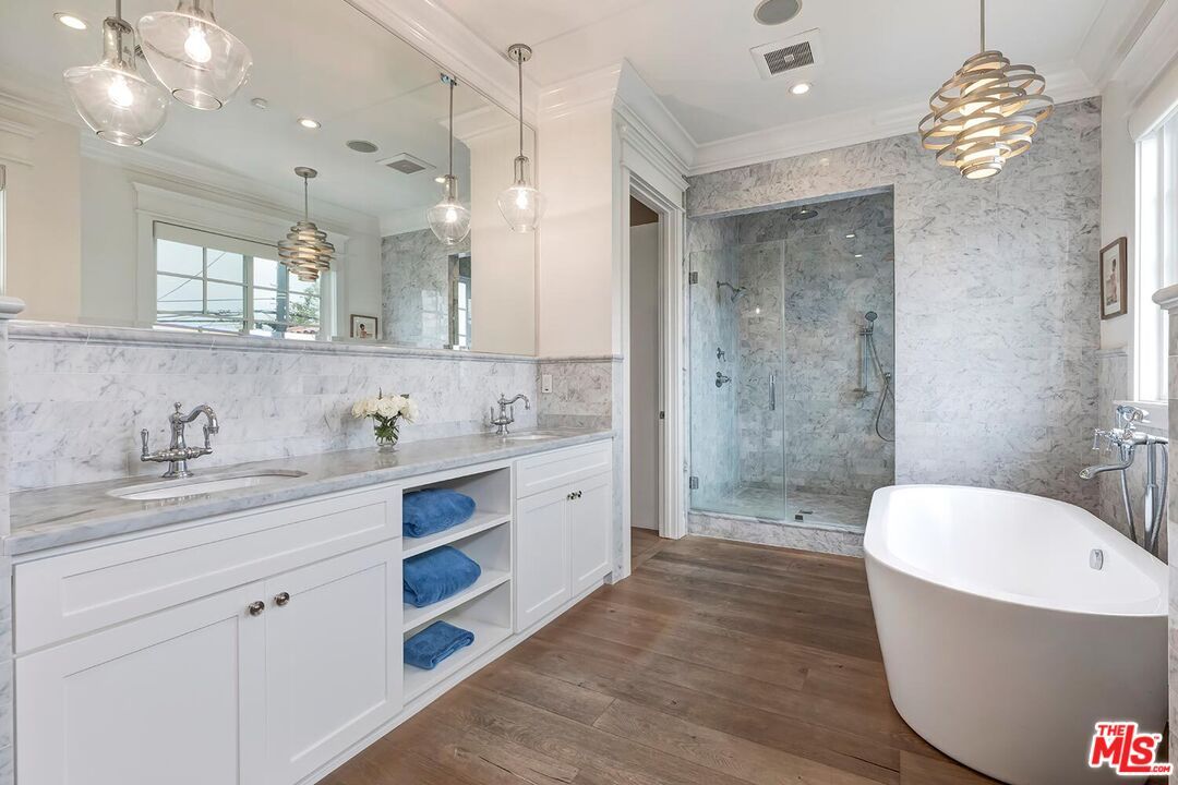 Bathroom, Dual Sink Vanities, Free Standing Baths, Glass Shower, Interior, Marble Walls, Pendant Lights, Recessed Lighting, Wood Texture Flooring