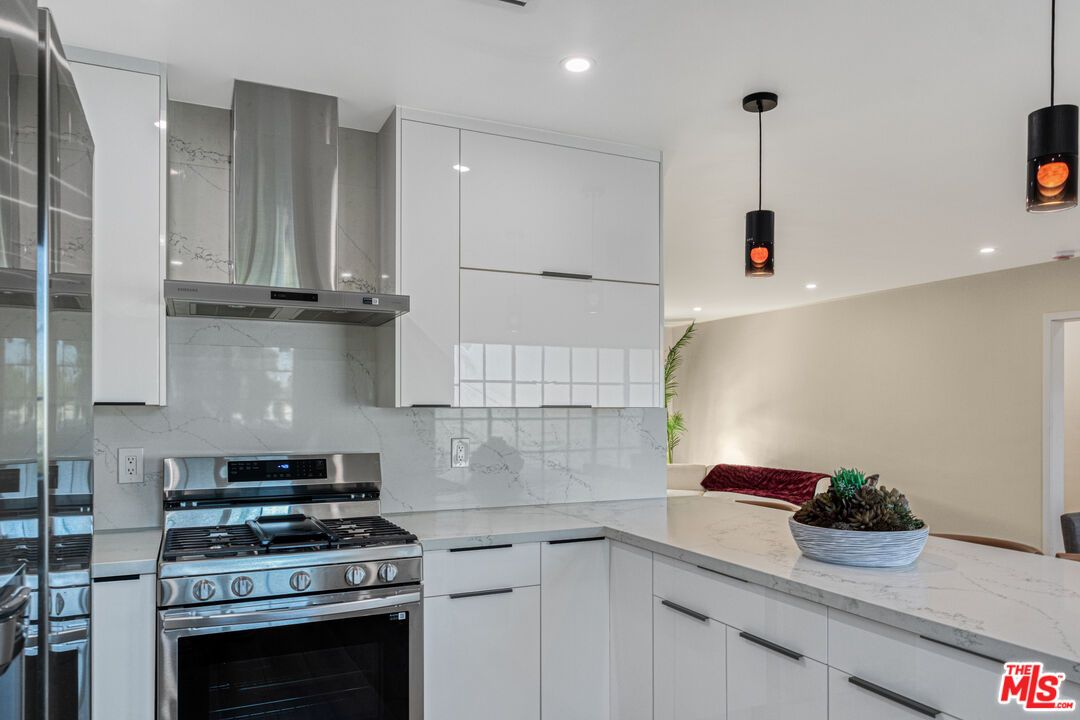 Interior, Kitchen, Marble Walls, Pendant Lights, Recessed Lighting, Stainless Steel Appliances