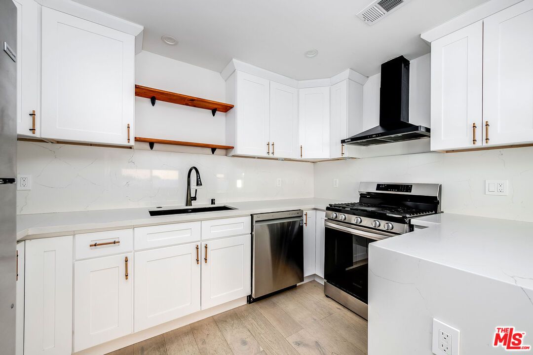 Interior, Kitchen, Marble Walls, Recessed Lighting, Stainless Steel Appliances, Wood Texture Flooring